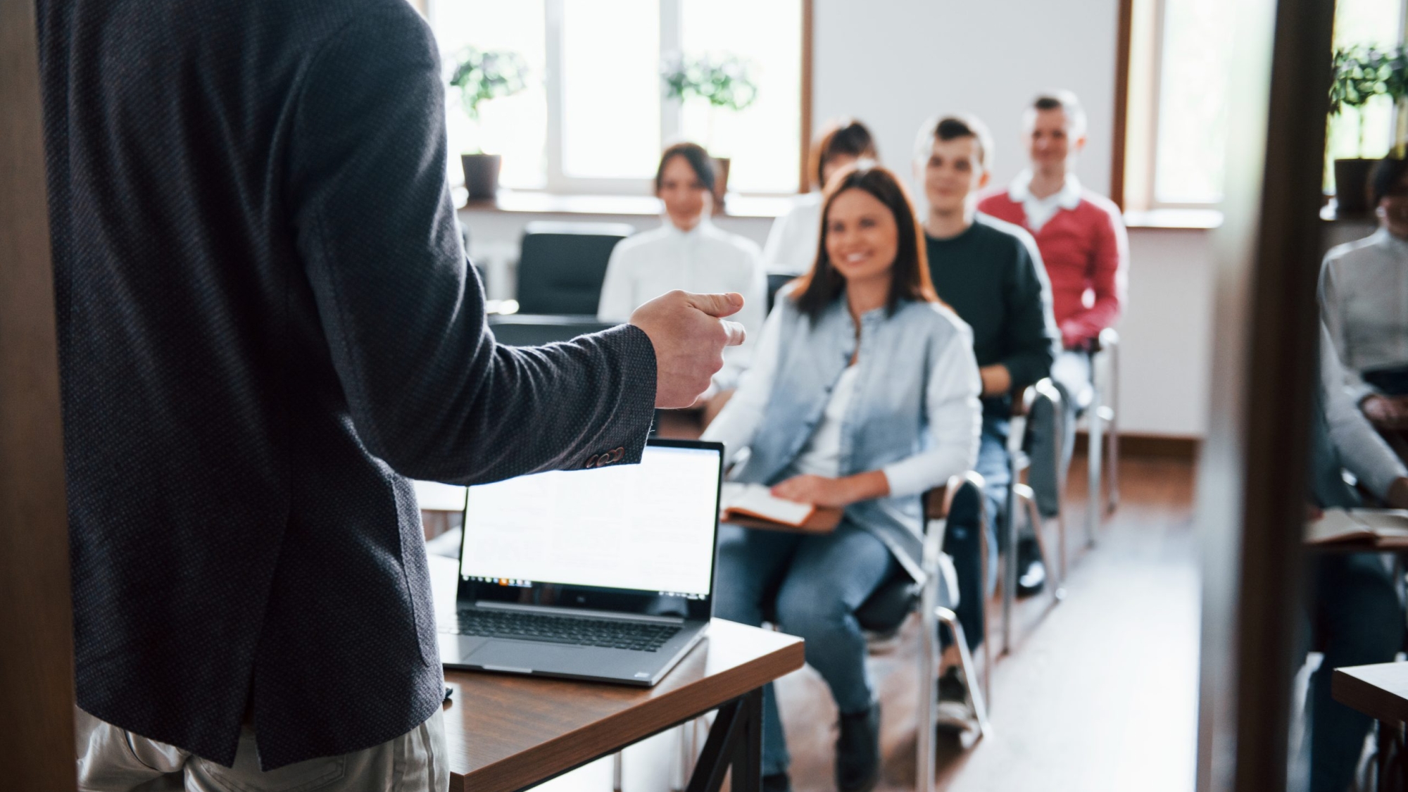 Cheerful mood. Group of people at business conference in modern classroom at daytime.
