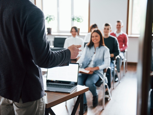 Cheerful mood. Group of people at business conference in modern classroom at daytime.
