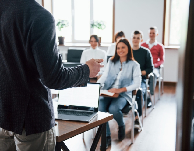 Cheerful mood. Group of people at business conference in modern classroom at daytime.